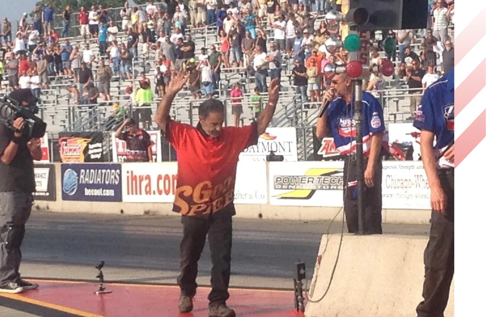 Excited man raises arms at race event